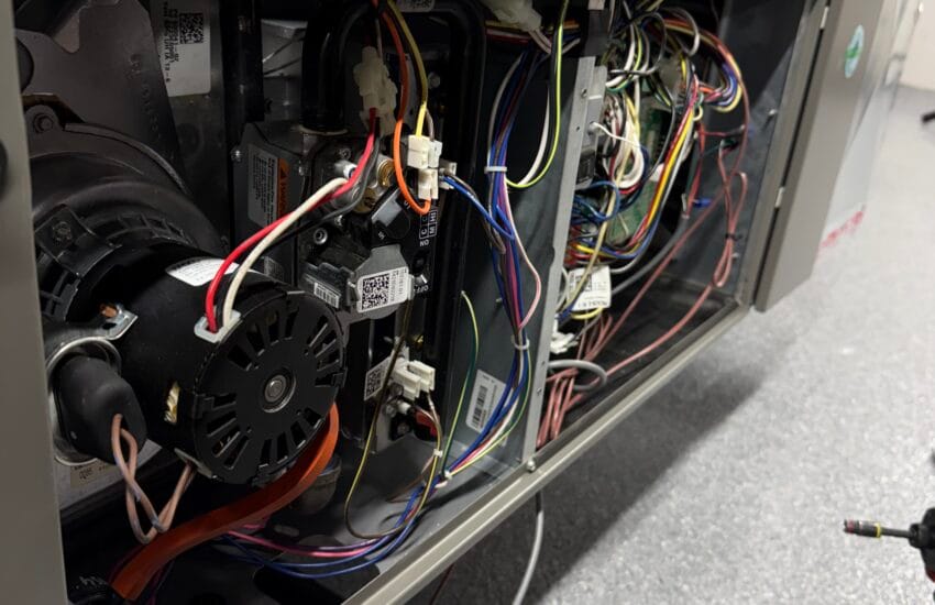 HVAC technician repairing a furnace in a Chicago home crawl space for safe and efficient heating